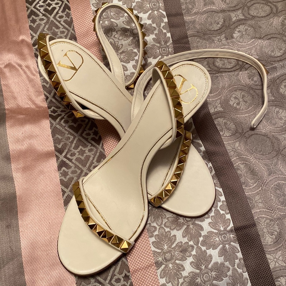 White and gold spiked heels.